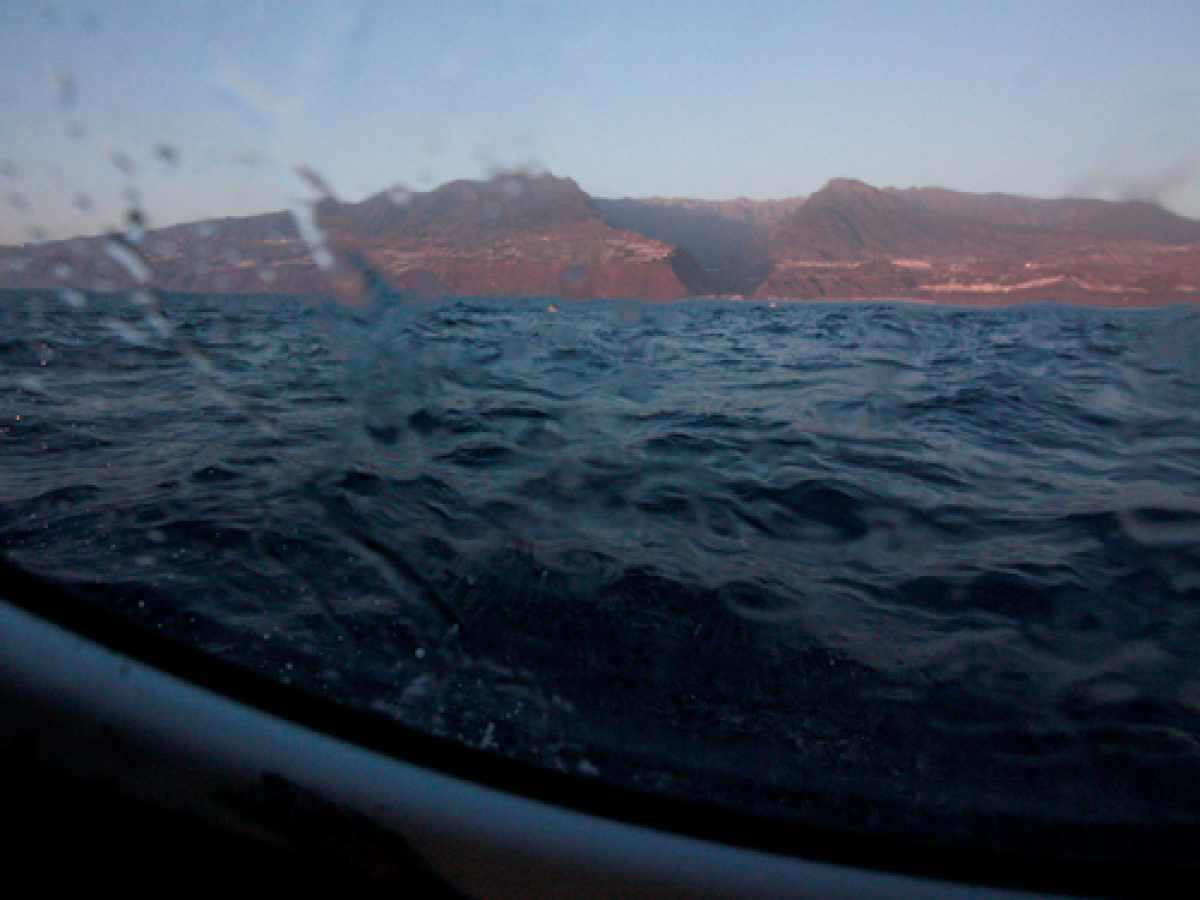 a body of water with a mountain in the background