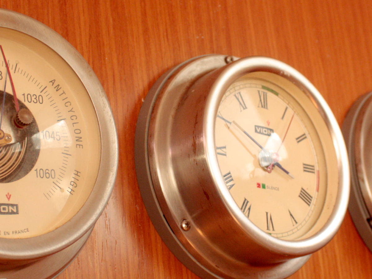 a clock sitting on top of a wooden table